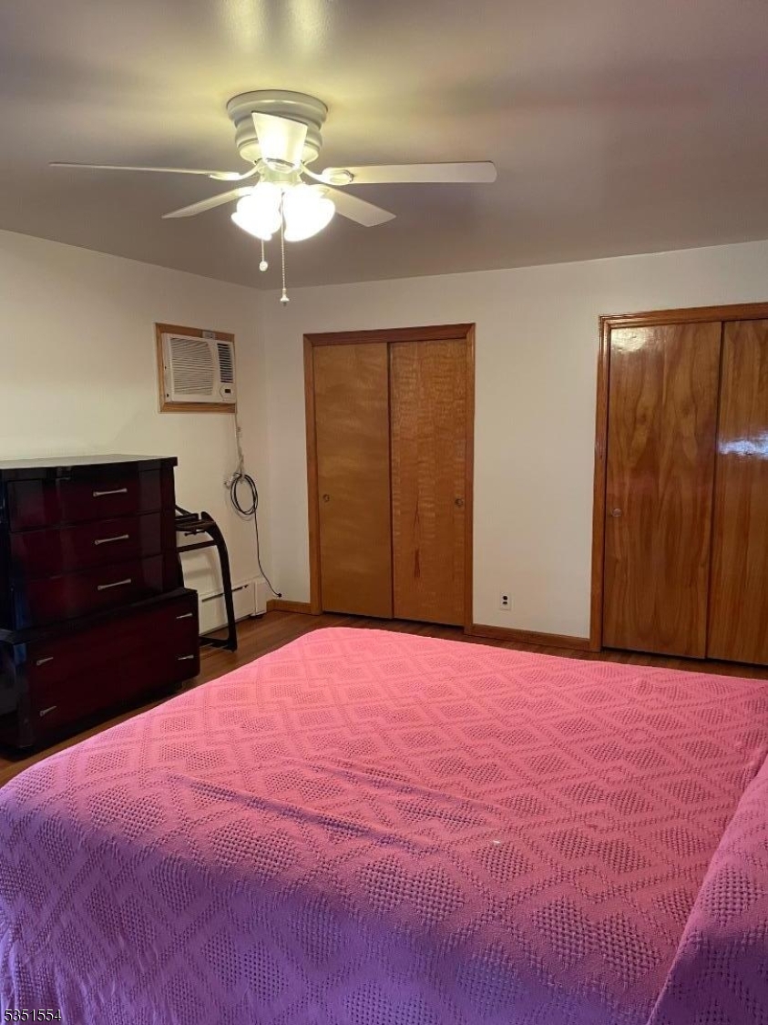 72 Baldwin Place, Unit 2 Bloomfield, NJ 07003 - Photo 12 of 14 a bedroom with a bed and a dresser