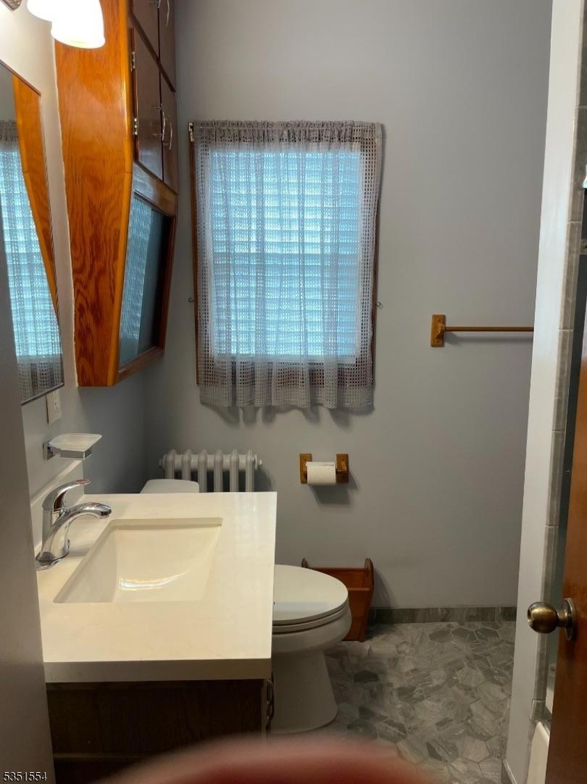 72 Baldwin Place, Unit 2 Bloomfield, NJ 07003 - Photo 13 of 14 a bathroom with a sink toilet and shower