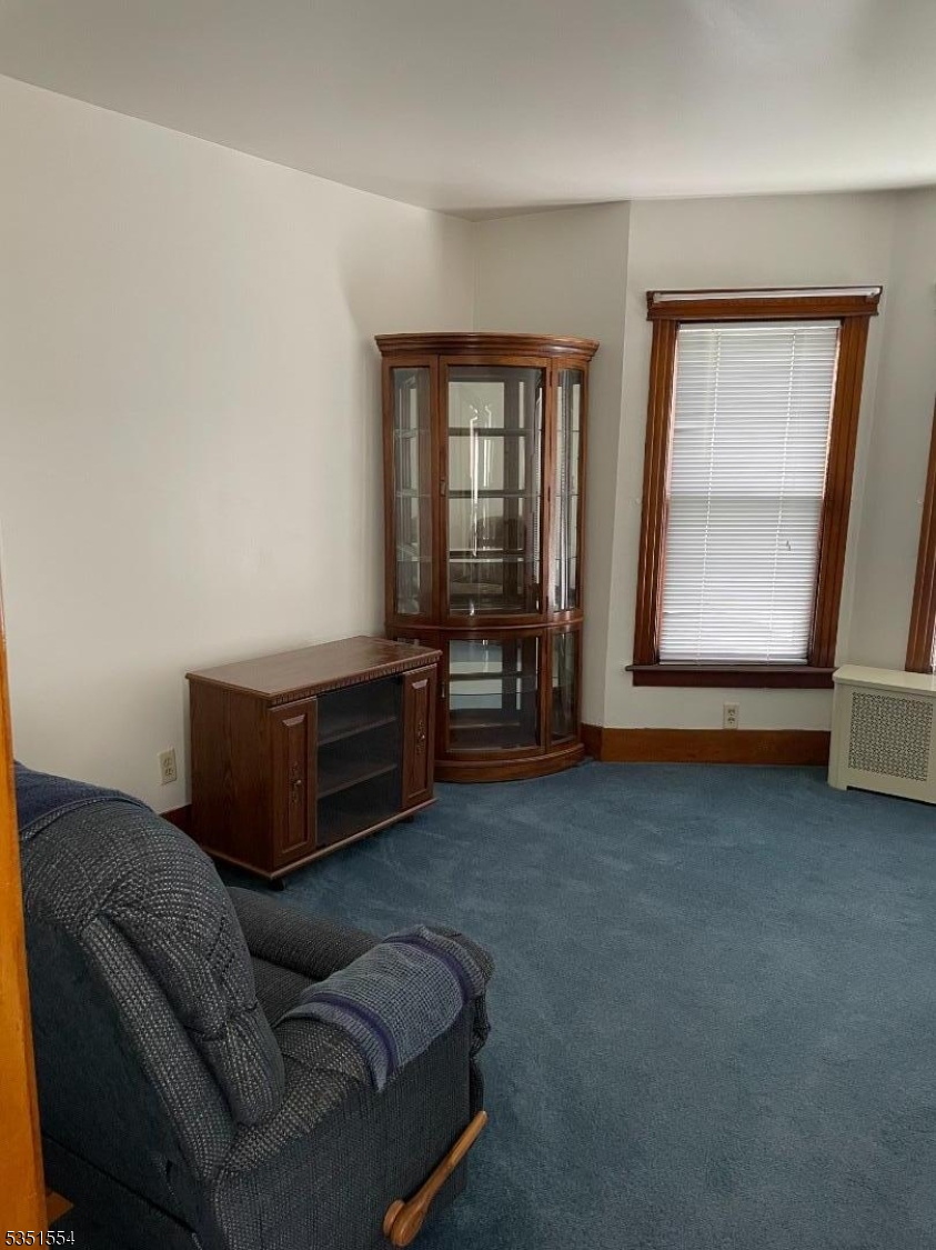 72 Baldwin Place, Unit 2 Bloomfield, NJ 07003 - Photo 2 of 14 a living room with furniture and a window