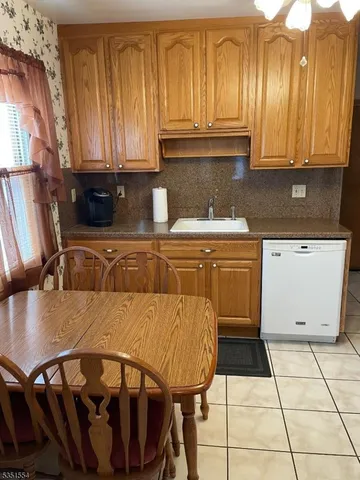 a kitchen with a sink a microwave and cabinets