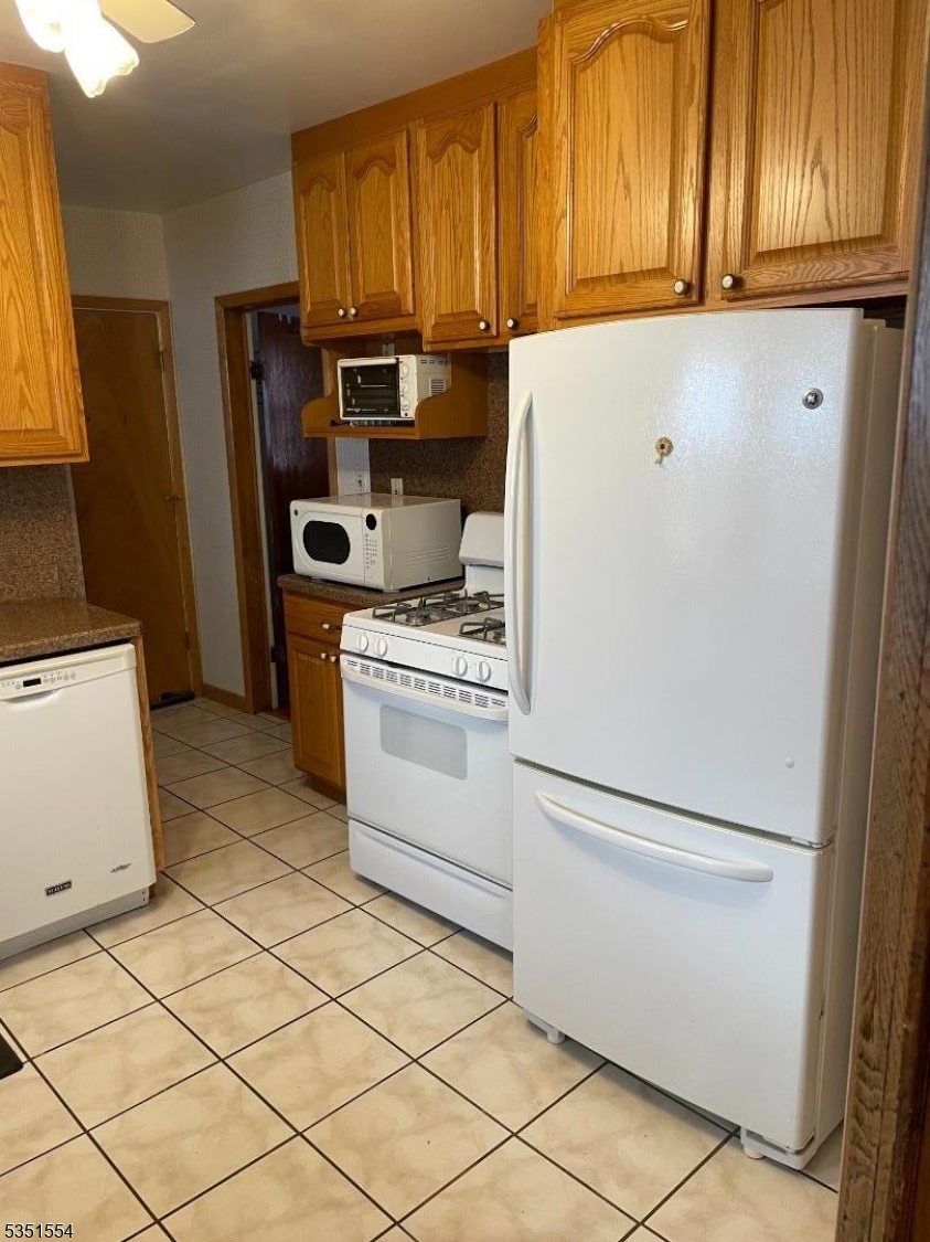72 Baldwin Place, Unit 2 Bloomfield, NJ 07003 - Photo 7 of 14 a kitchen with a refrigerator sink and cabinets