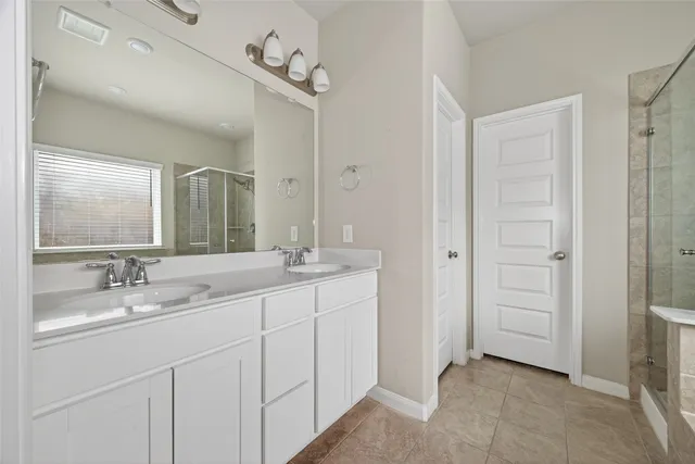 a bathroom with a double vanity sink and mirror