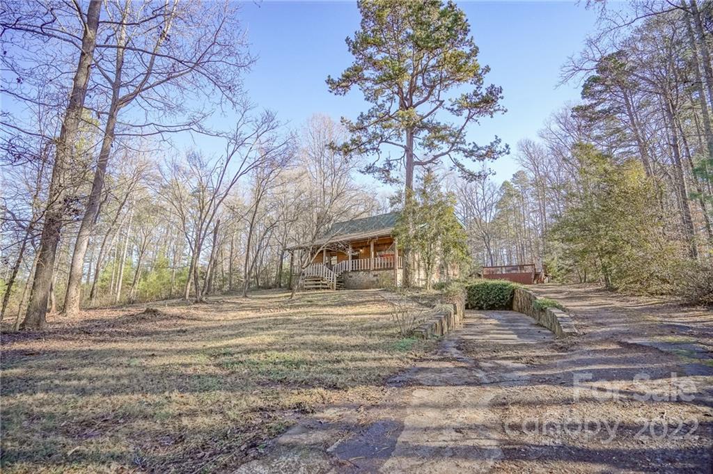 100 Rutledge Road Mount Holly, NC 28120 - Photo 2 of 44 a backyard of a house with large trees