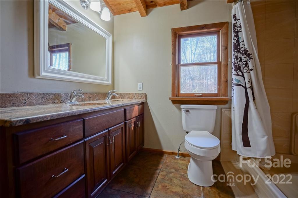 100 Rutledge Road Mount Holly, NC 28120 - Photo 29 of 44 a bathroom with a granite countertop toilet sink and mirror