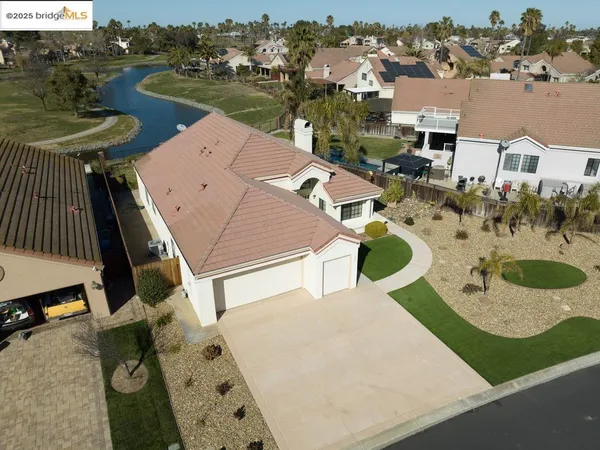 an aerial view of a house with outdoor space and lake view