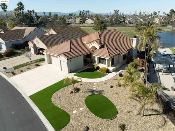 an aerial view of a house with outdoor space and lake view