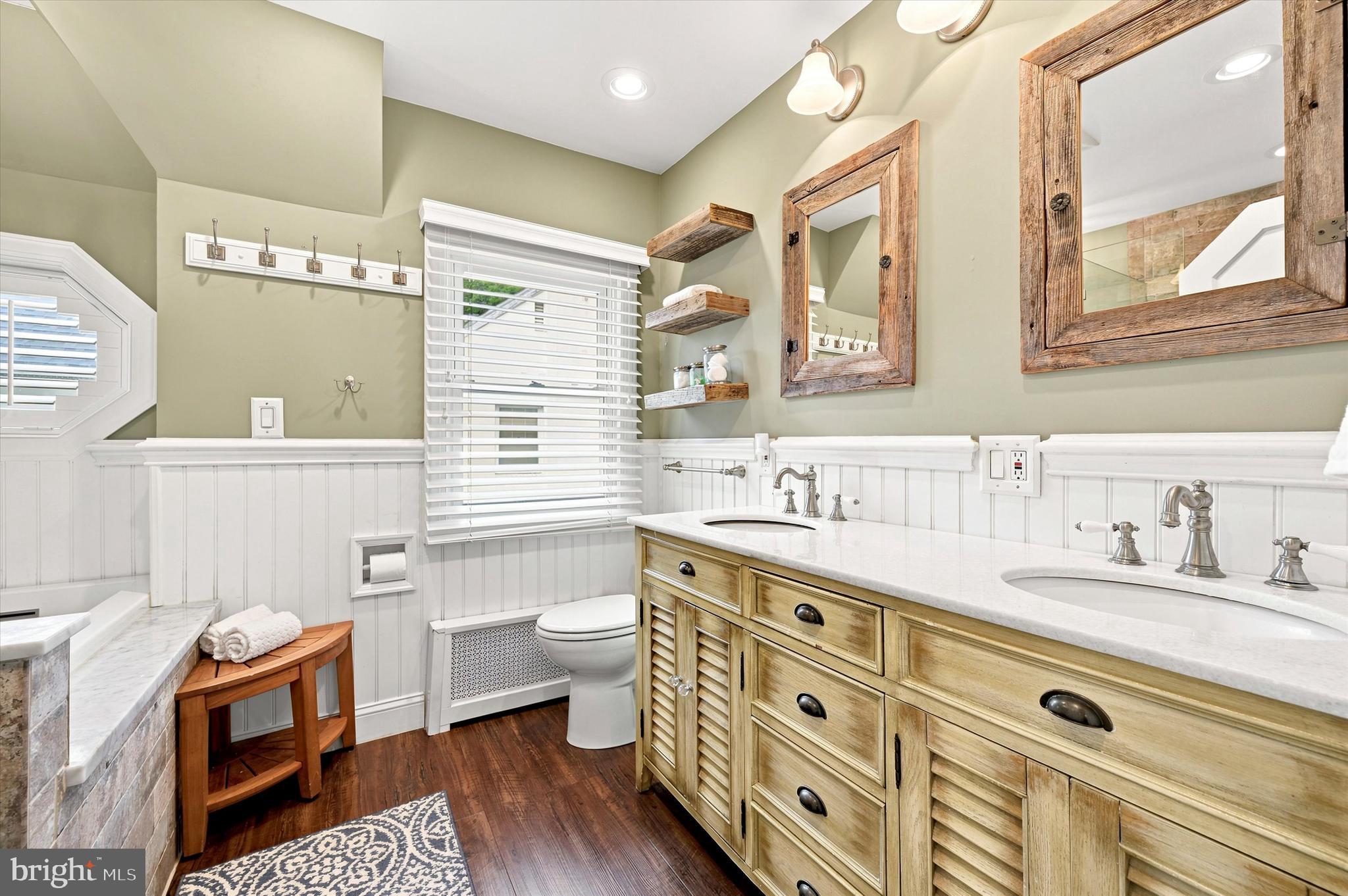 1468 Hampstead Road Wynnewood, PA 19096 - Photo 16 of 29 a spacious bathroom with a granite countertop toilet sink and mirror