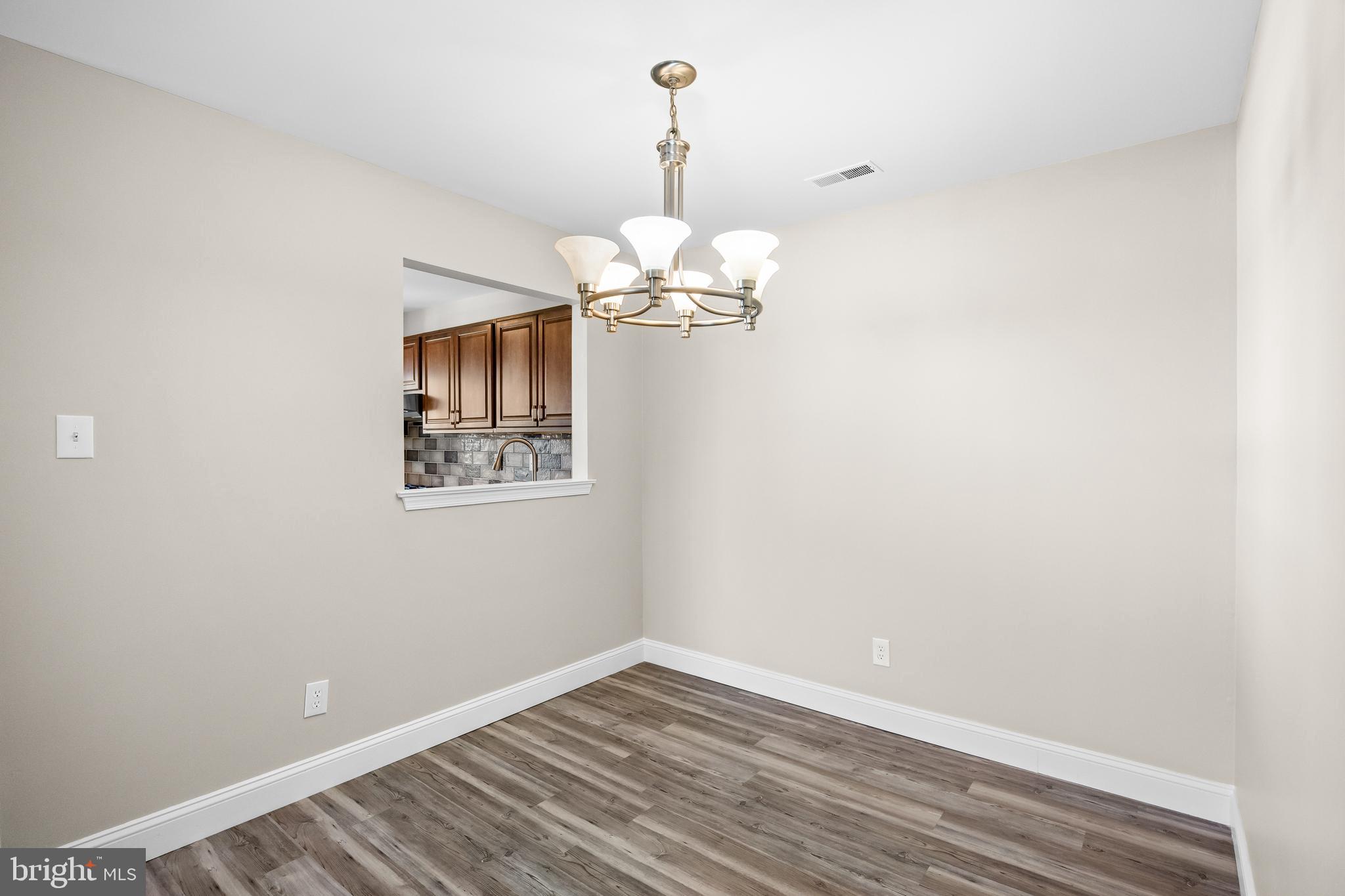 620 Covington Court Sewell, NJ 08080 - Photo 14 of 26 a view of a room with wooden floor chandelier and closet