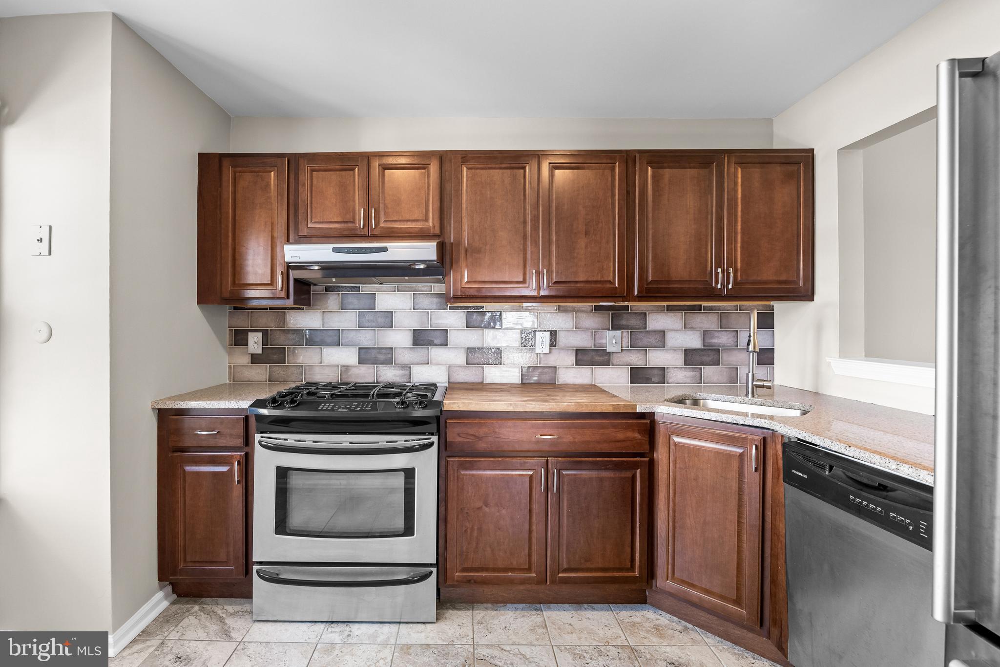 620 Covington Court Sewell, NJ 08080 - Photo 5 of 26 a kitchen with a stove sink and cabinets