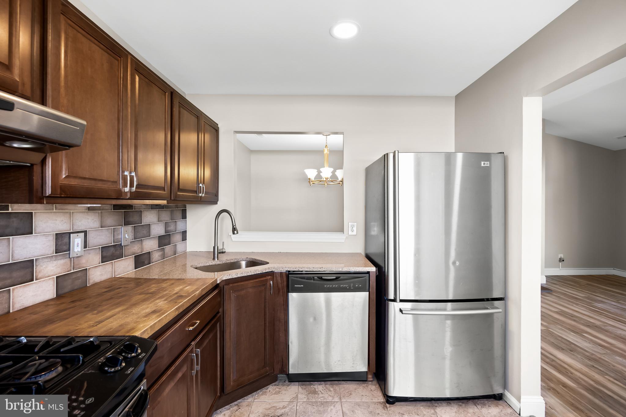 620 Covington Court Sewell, NJ 08080 - Photo 6 of 26 a kitchen with stainless steel appliances granite countertop a refrigerator stove a sink and a microwave