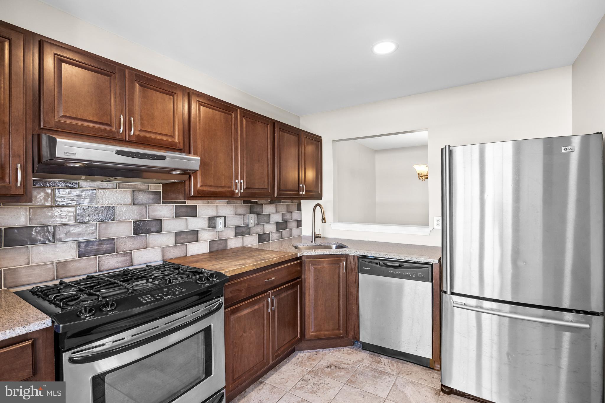 620 Covington Court Sewell, NJ 08080 - Photo 7 of 26 a kitchen with granite countertop a stove sink and refrigerator