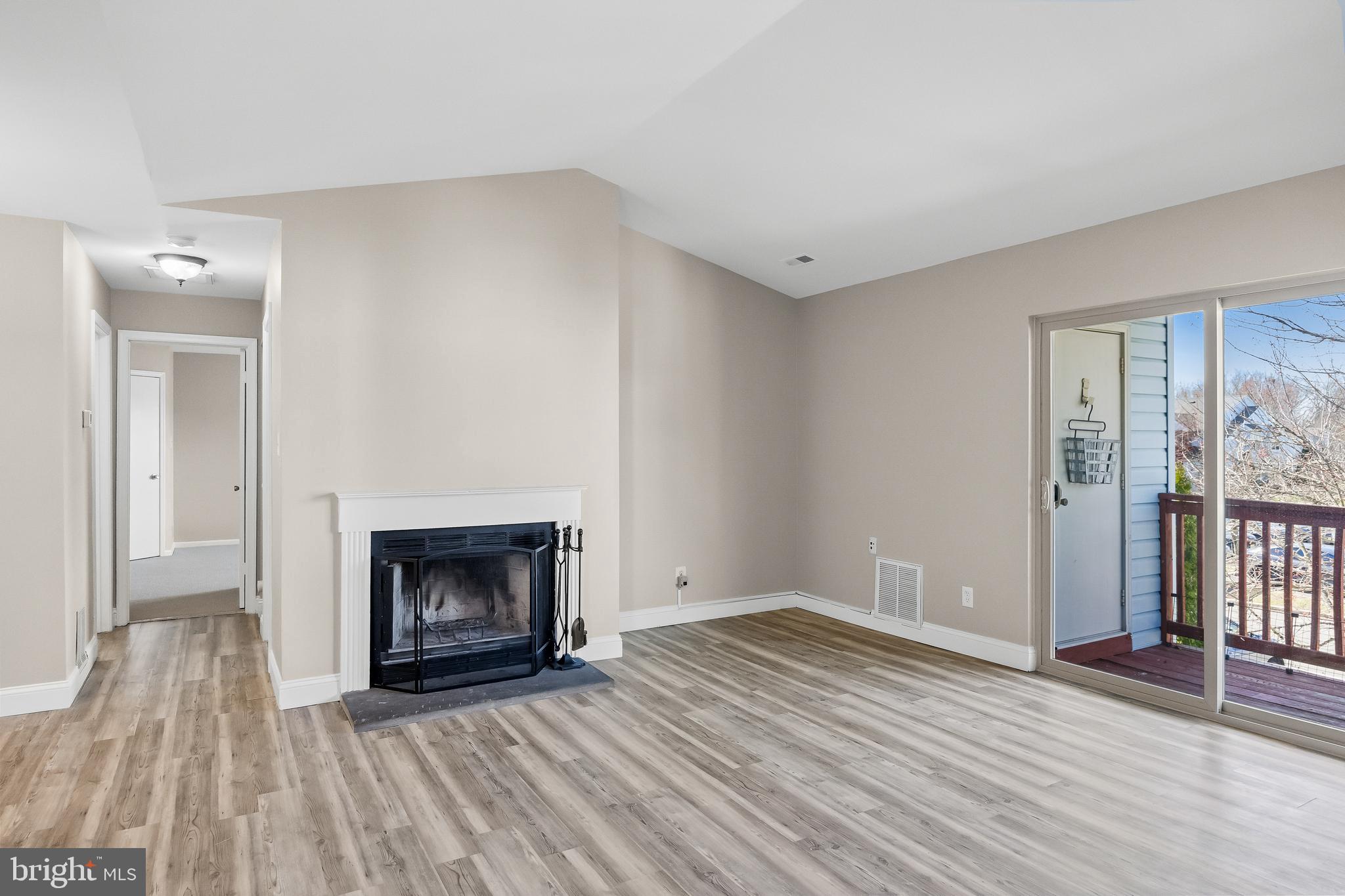 620 Covington Court Sewell, NJ 08080 - Photo 8 of 26 a view of an empty room with wooden floor fireplace and a window