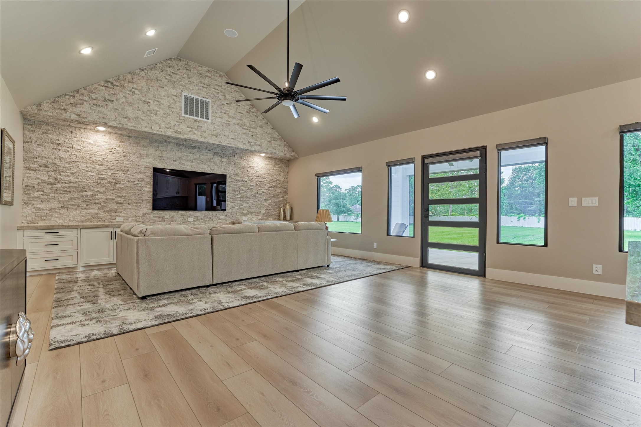 1907 Woerner Road Houston, TX 77090 - Photo 32 of 50 Family room in guest's quarters with stacked stone walls and television. This home is ideal for guests that visit for extended stays.