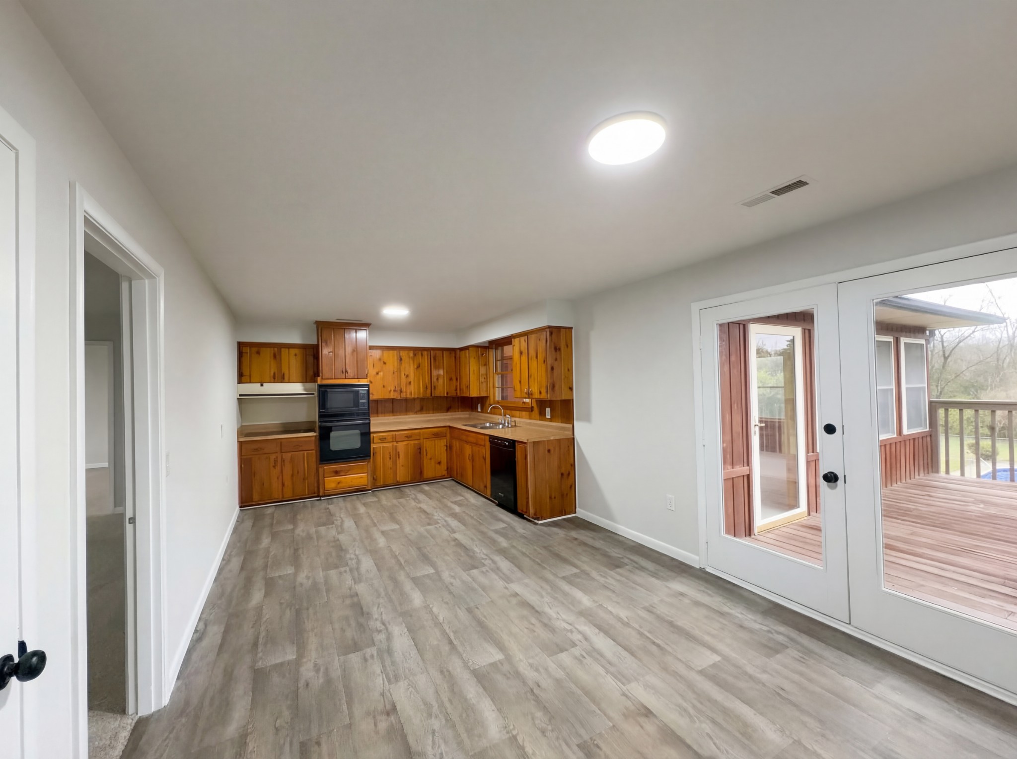 823 Apple Valley Road Madison, TN 37115 - Photo 9 of 23 a view of a kitchen with wooden floor and electronic appliances