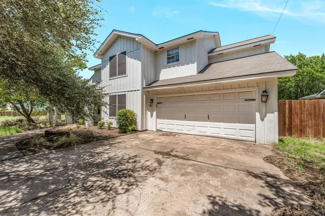 a view of backyard of house and trees