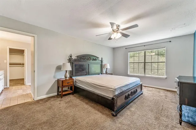 a spacious bedroom with a bed and a window