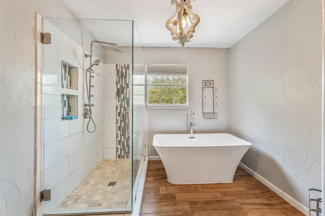 a bathroom with a bathtub and shower