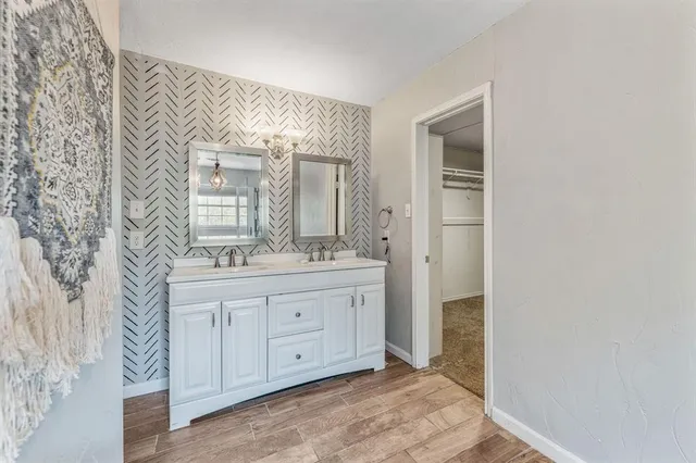 a bathroom with a granite countertop sink a mirror and a