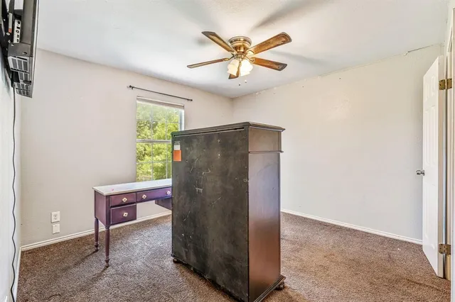 a view of a livingroom with a ceiling fan and a window