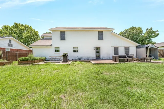 a view of a house with backyard and sitting area