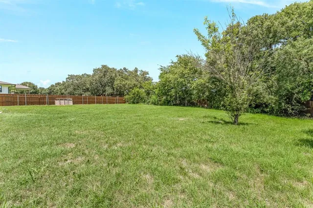 a backyard of a house with lots of green space