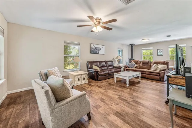 a living room with furniture and a wooden floor