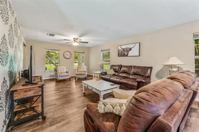 a living room with furniture and wooden floor