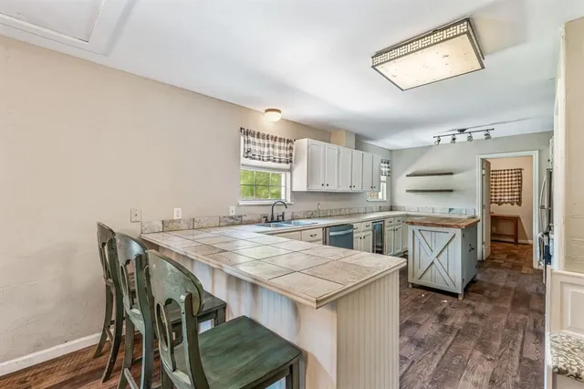 a kitchen that has a table and chairs in it