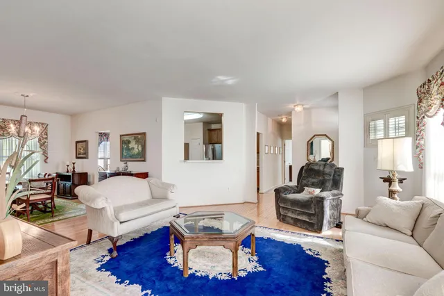 a living room with furniture rug and wooden floor