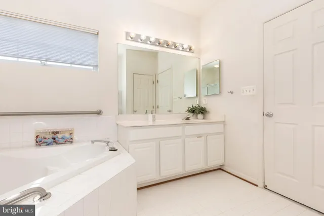 a spacious bathroom with a double vanity sink mirror and