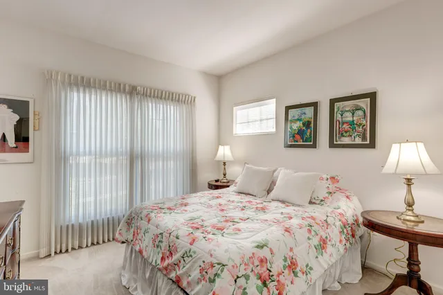 a bedroom with a bed and a lamp on table