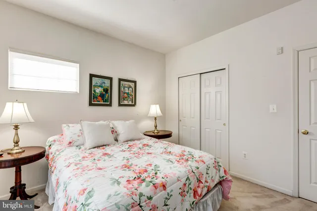 a bedroom with a bed and a lamp