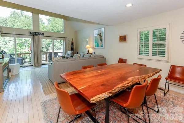 a dining room with a table chairs and a kitchen view