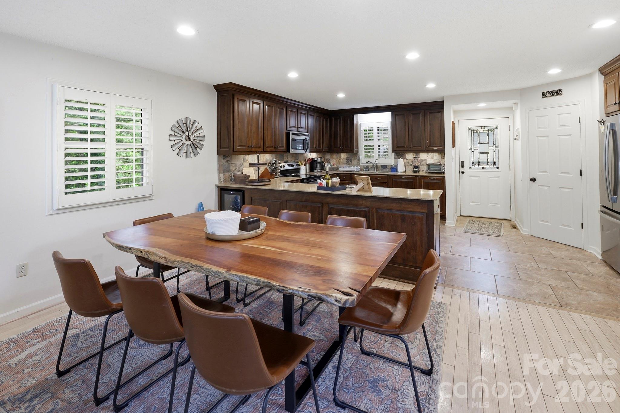 130 Edwards Point Lake Lure, NC 28746 - Photo 11 of 35 a kitchen with a dining table chairs and refrigerator