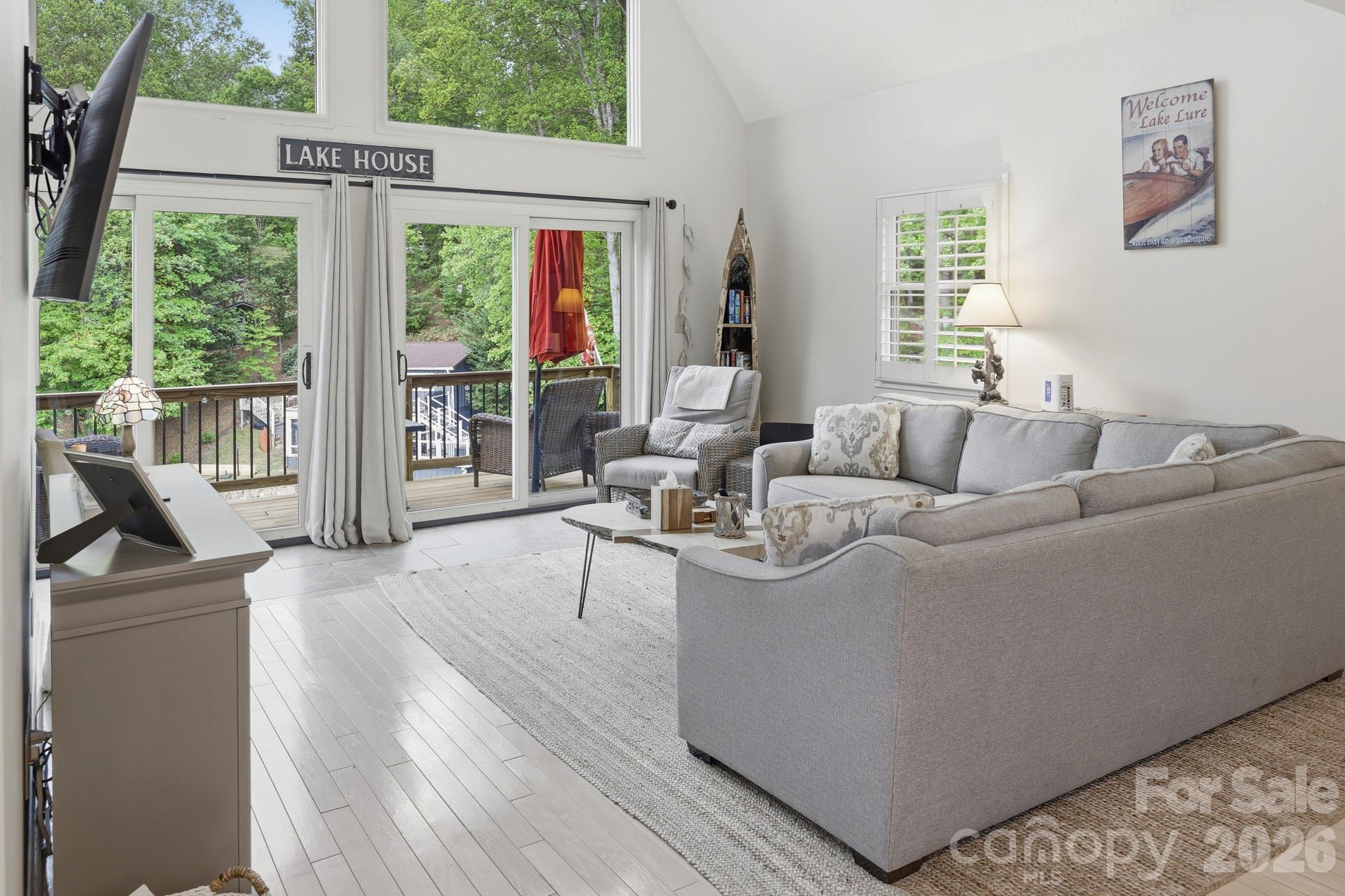 130 Edwards Point Lake Lure, NC 28746 - Photo 12 of 35 a living room with furniture and large windows