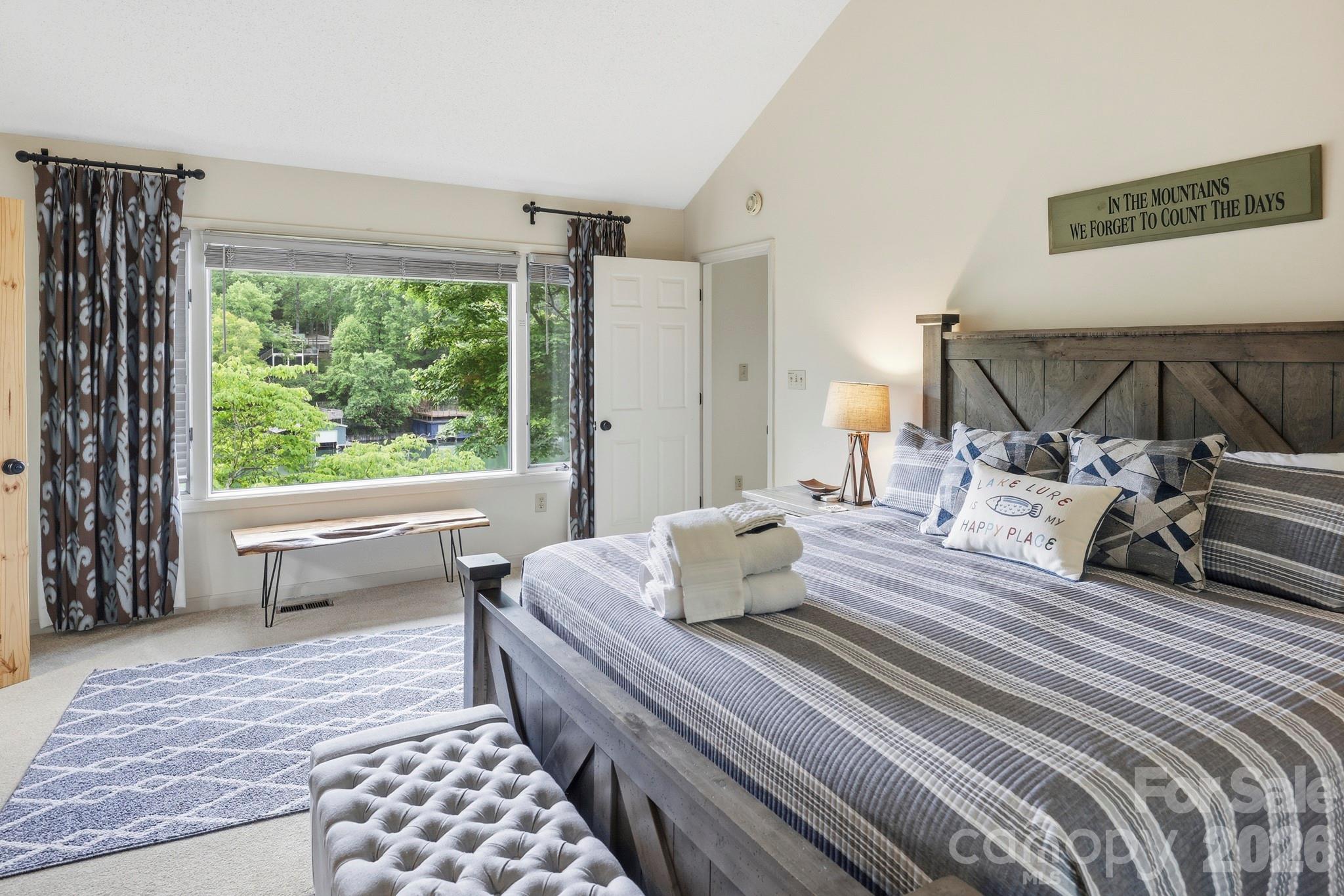 130 Edwards Point Lake Lure, NC 28746 - Photo 17 of 35 a bedroom with a bed and wooden floor