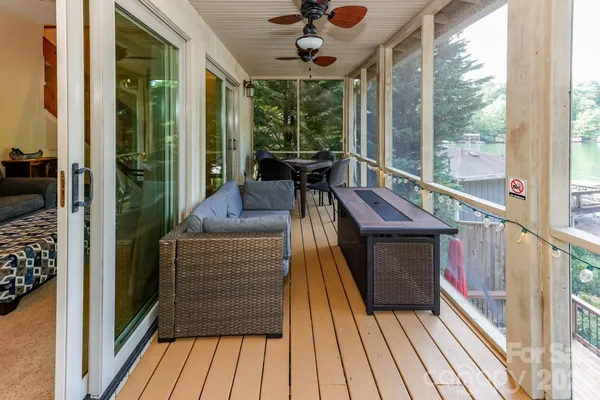 a view of balcony with furniture and wooden floor