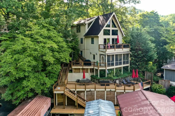 a view of house with a yard and sitting area