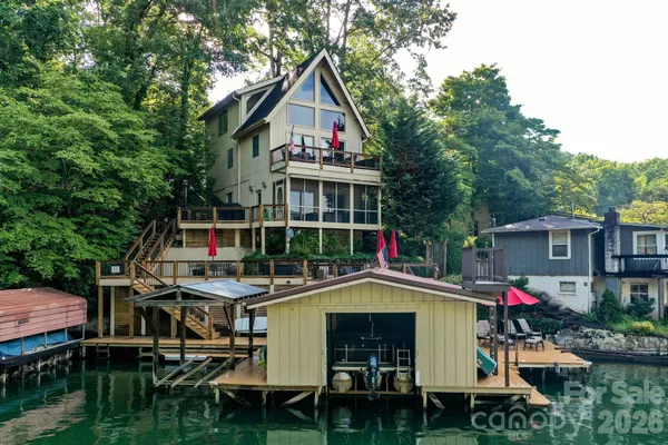 a small swimming pool is sitting in front of a house