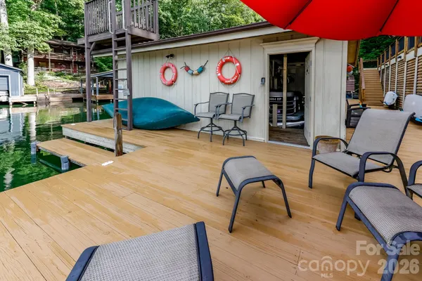 a patio with a table and chairs and potted plants
