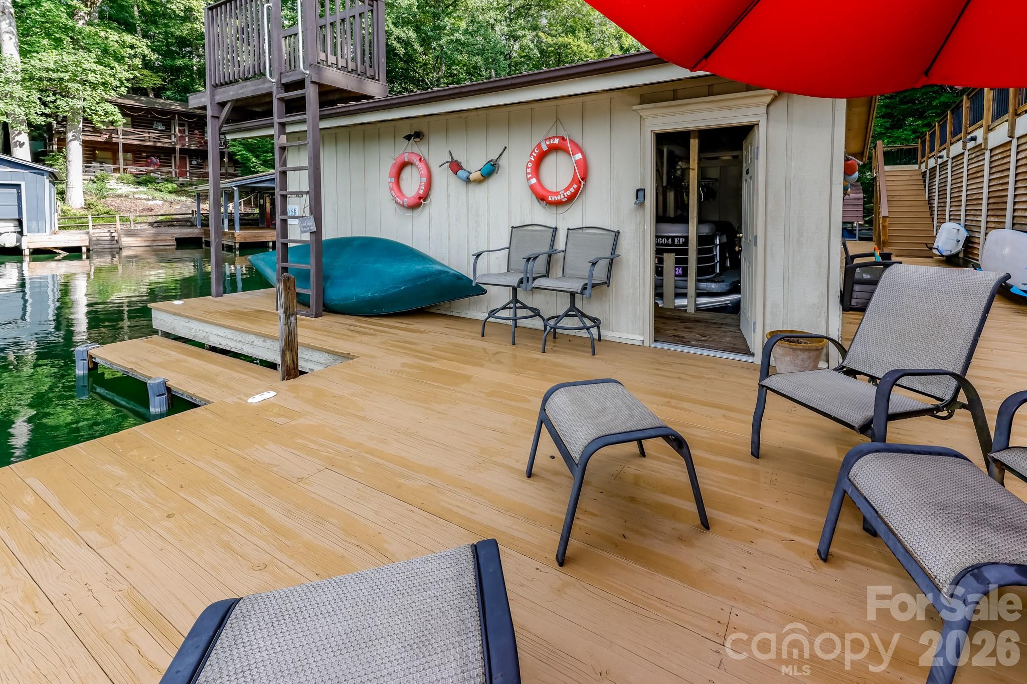 130 Edwards Point Lake Lure, NC 28746 - Photo 28 of 35 a patio with a table and chairs and potted plants
