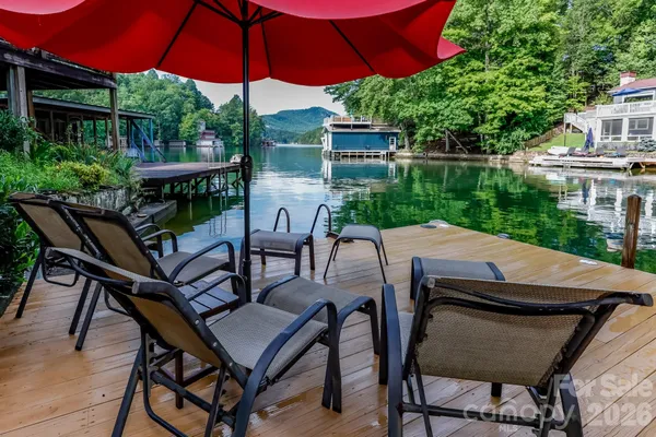 a patio with a table and chairs under an umbrella