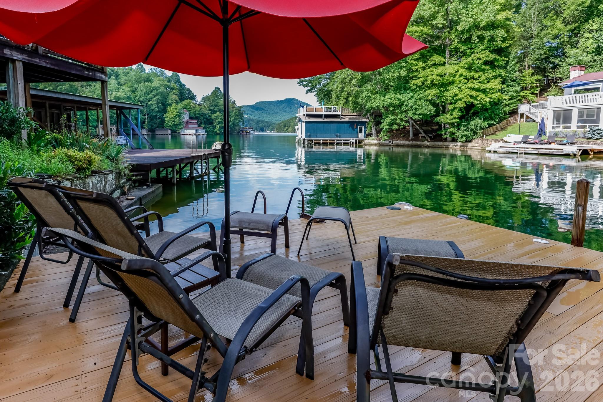 130 Edwards Point Lake Lure, NC 28746 - Photo 6 of 35 a patio with a table and chairs under an umbrella