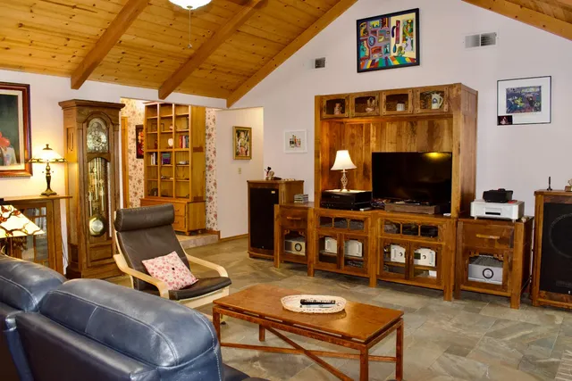 a living room with furniture kitchen view and a fireplace