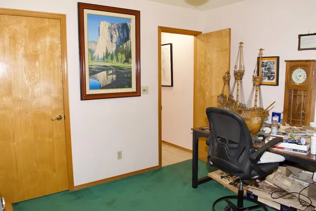a bedroom with a bed and potted plant