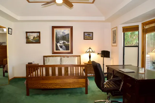 a bathroom with a granite countertop toilet sink and mirror