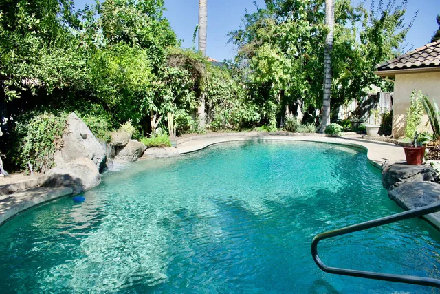 a view of a house with backyard sitting area and garden