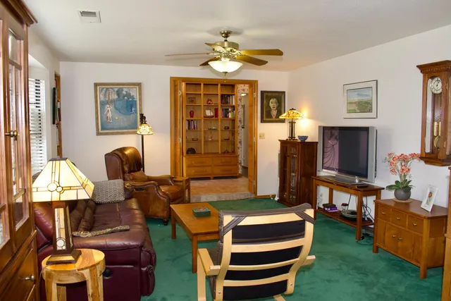 a living room with fireplace furniture and a window
