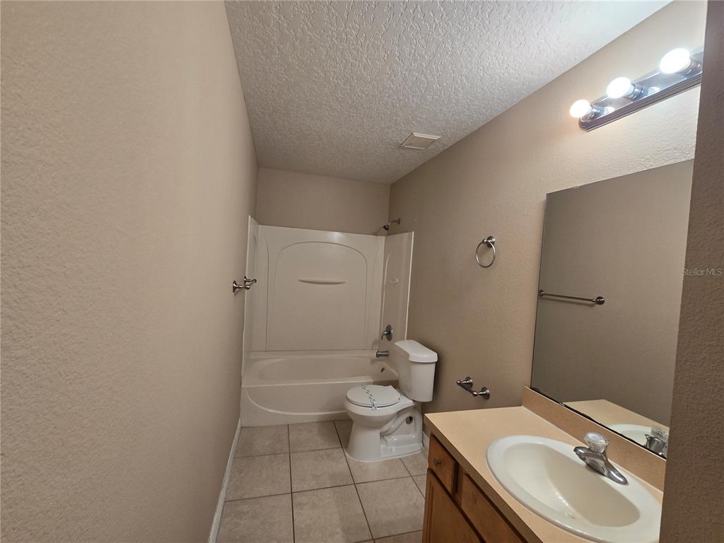 8 Windrose Drive Orlando, FL 32824 - Photo 11 of 23 a bathroom with a sink toilet and shower