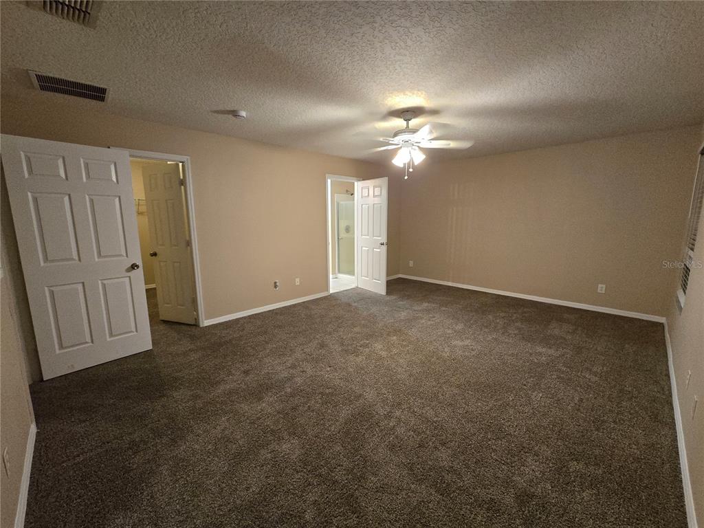 8 Windrose Drive Orlando, FL 32824 - Photo 16 of 23 an empty room with windows and fan
